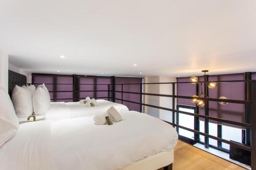 - 2 lits blancs dans une chambre avec fenêtre dans l'établissement Luxury loft in paris, à Paris