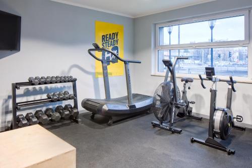 a gym with two treadmills and two exercise bikes at o3Hotel in Warsaw