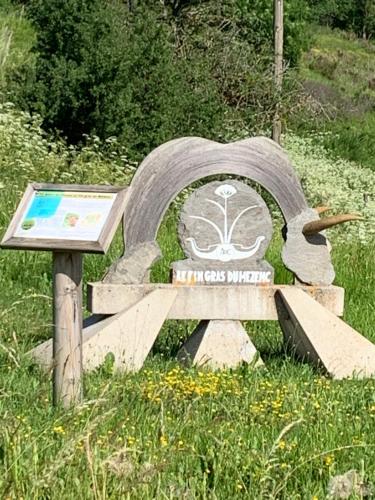 a bench sitting in the middle of a field at Auberge de la Tour in Freycenet-la-Tour