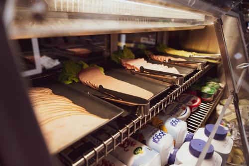 a refrigerator filled with lots of different types of food at Liljeholmens Stadshotell in Stockholm