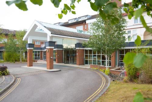 a building with a road in front of it at Regency Park Hotel, Health Club & Spa in Newbury