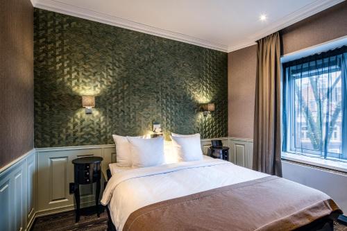 Säng eller sängar i ett rum på Hotel Sint Nicolaas