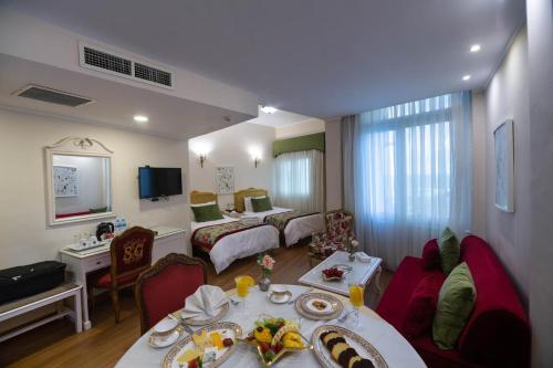 a living room with a table with food on it at San Giovanni Stanly Hotel in Alexandria