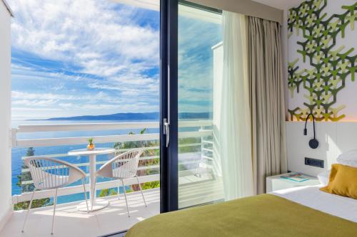 a bedroom with a view of the ocean at Bluesun Mala Berulia in Brela