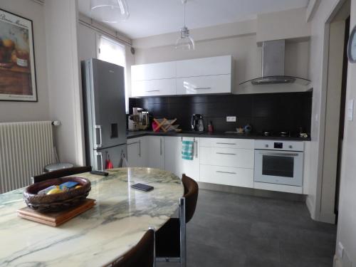 une cuisine avec une table avec un bol de fruits dessus dans l'établissement BERGERAC, à Bergerac