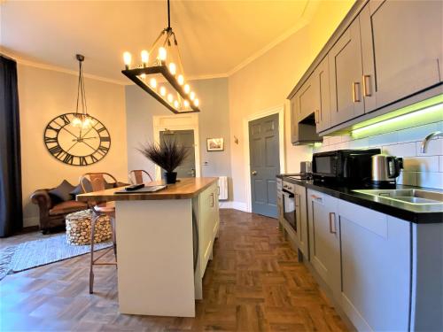 a kitchen with a counter top in a room at The Leeming at Claremont Apartments in Leeds