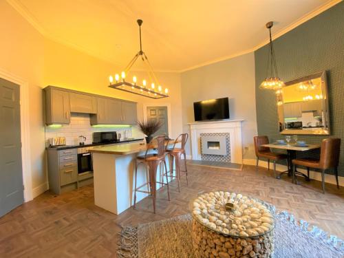 a kitchen and living room with a table and chairs at The Leeming at Claremont Apartments in Leeds