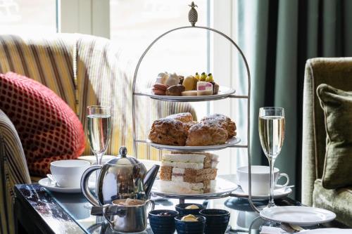 a tray of pastries and drinks on a table at Bowood Hotel, Spa, and Golf Resort in Chippenham