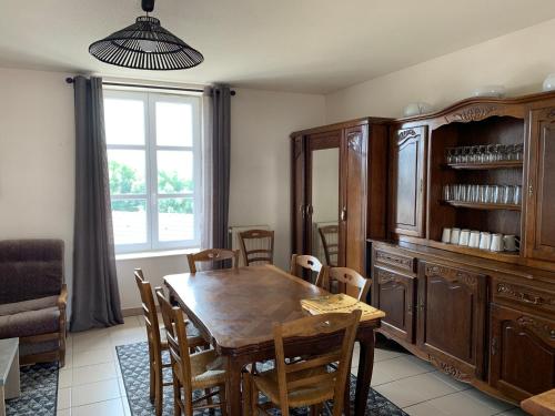 a dining room with a wooden table and chairs at Auberge de la Tour in Freycenet-la-Tour