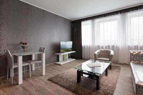 a living room with a table and a couch at Hotel Asahi in Düsseldorf