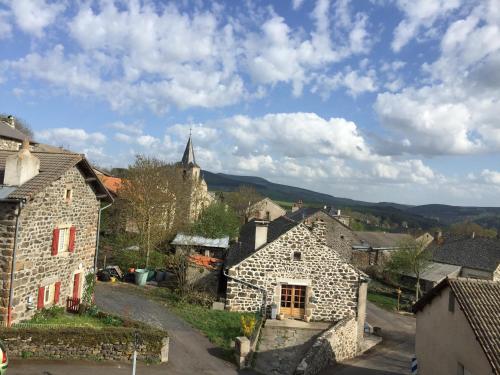 an old village with a church in the background at Auberge de la Tour in Freycenet-la-Tour