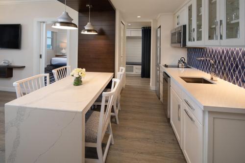 a kitchen with white cabinets and white appliances at Resort at Longboat Key Club in Sarasota