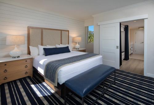 a bedroom with a large bed and a dresser and lamp at Resort at Longboat Key Club in Sarasota