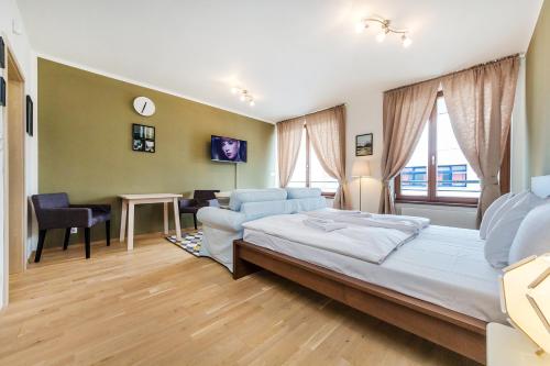 a bedroom with a bed and a living room at REZIDENCE U VLTAVY in Prague