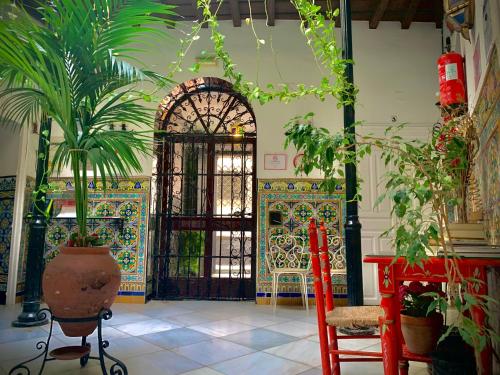 una habitación con una puerta con plantas delante de ella en Hostal Lis en Sevilla