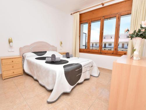 a bedroom with a bed and a large window at Apartment Helen by Interhome in Torredembarra