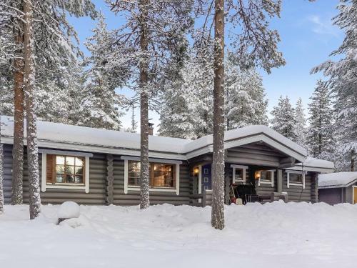 a log cabin in the woods in the snow at Holiday Home Pasyni by Interhome in Sirkka