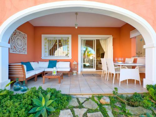 a patio with an archway and a table and chairs at Holiday Home Campoverde by Interhome in Denia
