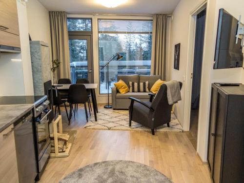 a kitchen and living room with a couch and a table at Holiday Home Ylälänsi 3 as 5 by Interhome in Ylläsjärvi