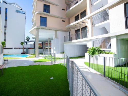 an apartment building with a lawn in front of it at Apartment Isea Calpe 02 by Interhome in Calpe