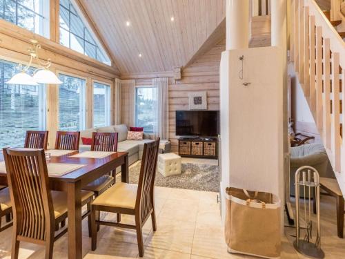 a kitchen and dining room with a table and chairs at Holiday Home Akavilla 2 by Interhome in Jämsä