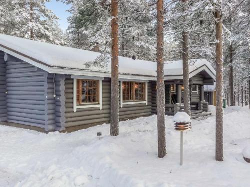 a log cabin in the snow with a parking meter at Holiday Home Pasyni by Interhome in Sirkka
