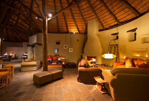 a large living room with couches and a fireplace at Wilderness Safaris Kulala Desert Lodge in Sesriem
