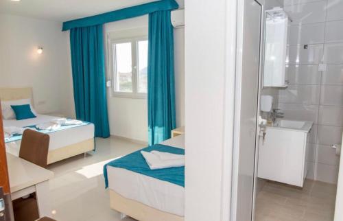 a small room with two beds and a bathroom at Apartmani Nela Sutomore in Sutomore