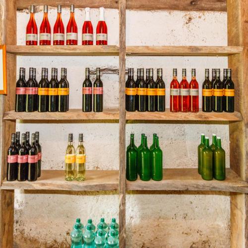 a display of different types of bottles on shelves at Ferienhaus Riegelnegg in Oberhaag