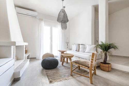 a living room with a couch and a table at The House of Cyclades in Návstathmos