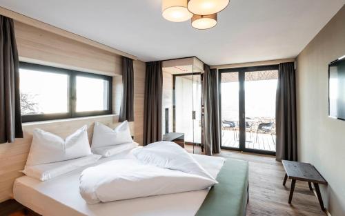 A bed or beds in a room at Aparthotel Panorama Living Dolomites