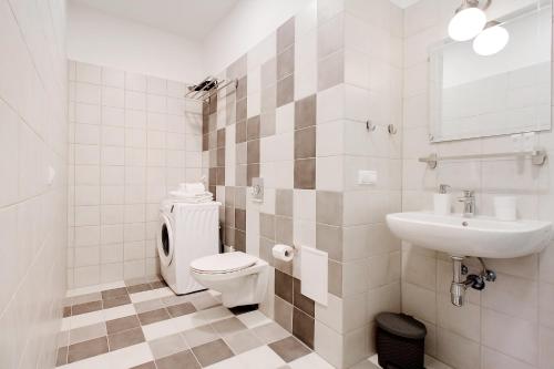 a bathroom with a toilet and a sink at Residential Barona Apartments in Riga Centre in Rīga