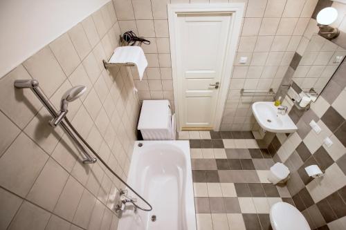 a small bathroom with a toilet and a sink at Residential Barona Apartments in Riga Centre in Rīga