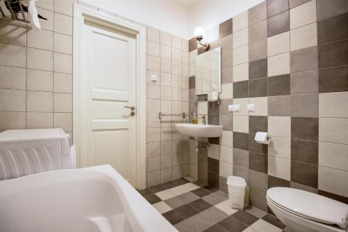 a bathroom with a toilet and a sink at Residential Barona Apartments in Riga Centre in Rīga