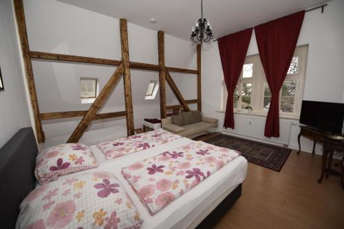 a bedroom with a bed with pillows on it at Ferienwohnung Villa Weyermann in Leichlingen