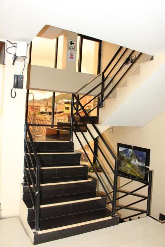 a staircase in a building with a stair case at Hotel Mantas Cusco in Cusco