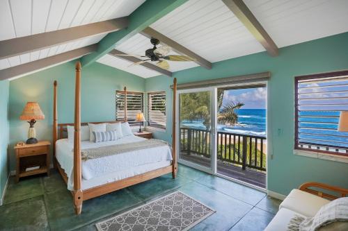 a bedroom with a bed and a balcony with the ocean at Kepuhi Hale TVNC #5156 in Hanalei