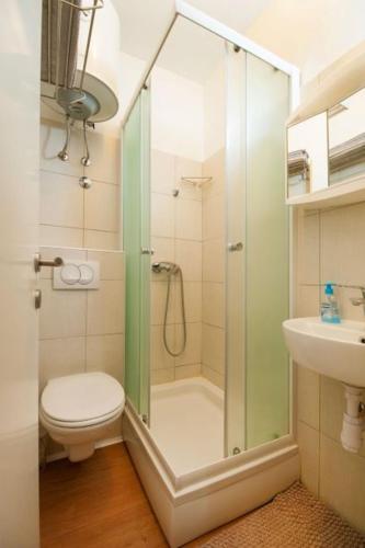 a bathroom with a shower with a toilet and a sink at Centar 1 Private Room with Ensuite and Kitchenette in Split