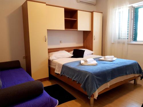 a bedroom with a bed with two towels on it at "Laurier" rooms & apartments in Čelina