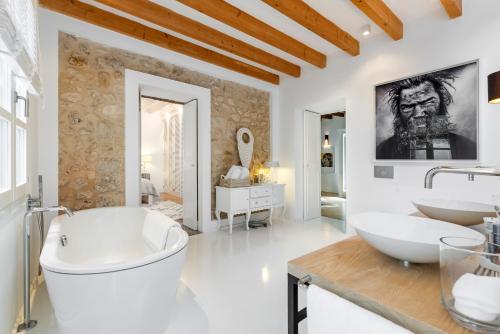 a white bathroom with two sinks and a tub at Ca Sa Doctora in El Port de la Selva