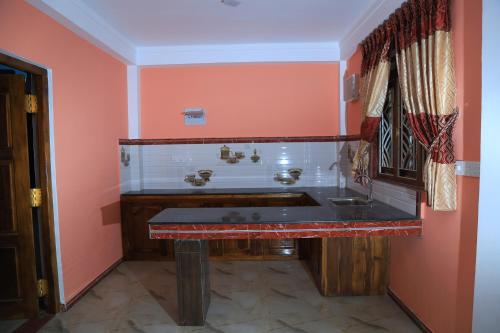 La salle de bains est pourvue d'un lavabo et d'un mur rouge. dans l'établissement Orr's Hill Day's Inn, à Trincomalee