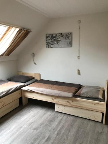 a bedroom with two beds in a room at Hotel Pieter de Coninck in Westkapelle