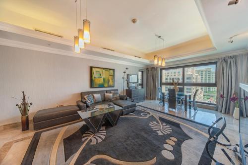 a living room with a couch and a table at bnbmehomes - Beach&Pool - Fairmont Residences - 3605 in Dubai