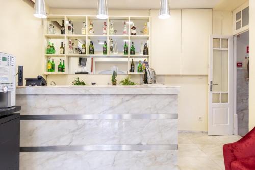 un bar dans une cuisine avec des armoires blanches dans l'établissement Hotel do Norte, à Porto