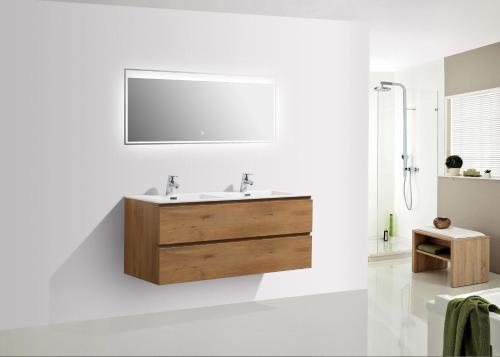 a bathroom with a sink and a mirror at Odense Apartments in Odense