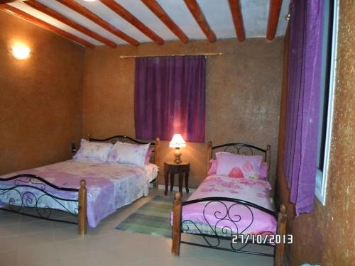 Cama ou camas em um quarto em Auberge Tilila