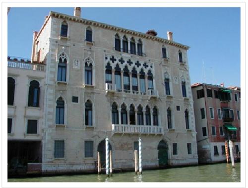 a large building sitting in the water in front at PALAZZO BERNARDO SAN POLO APARTMENT 100 MQ in Venice