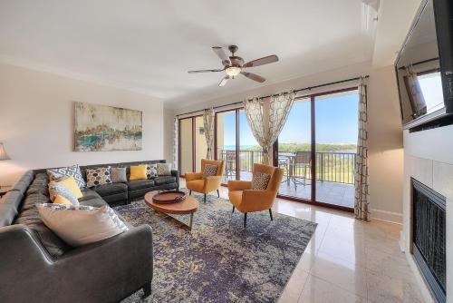 a living room with a couch and a fireplace at Sanctuary by the Sea 3114 in Santa Rosa Beach