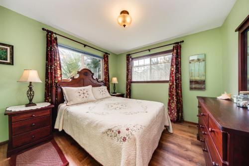 a bedroom with a bed and a dresser and a window at Shore Pine Hideaway in Lincoln City
