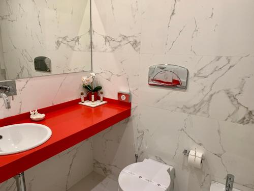 a bathroom with a sink and a toilet and a mirror at Urban Apartment Casa da Portela in Porto